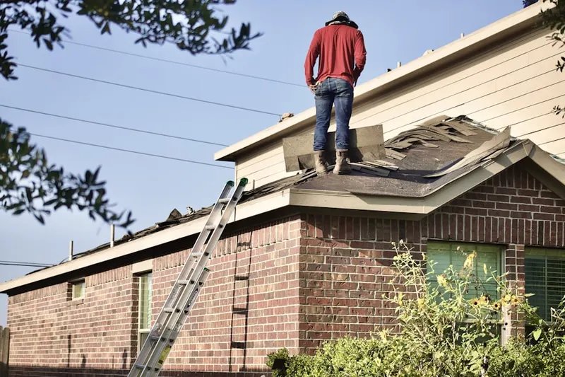 Professional roofer working on a residential roof in Norco